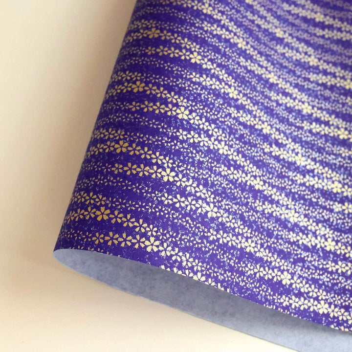 photo packshot d'une courbe de papier japonais yuzen chiyogami aux motifs de brise de fleurs dans les tons bleu nuit et dorés adeline klam (M968)