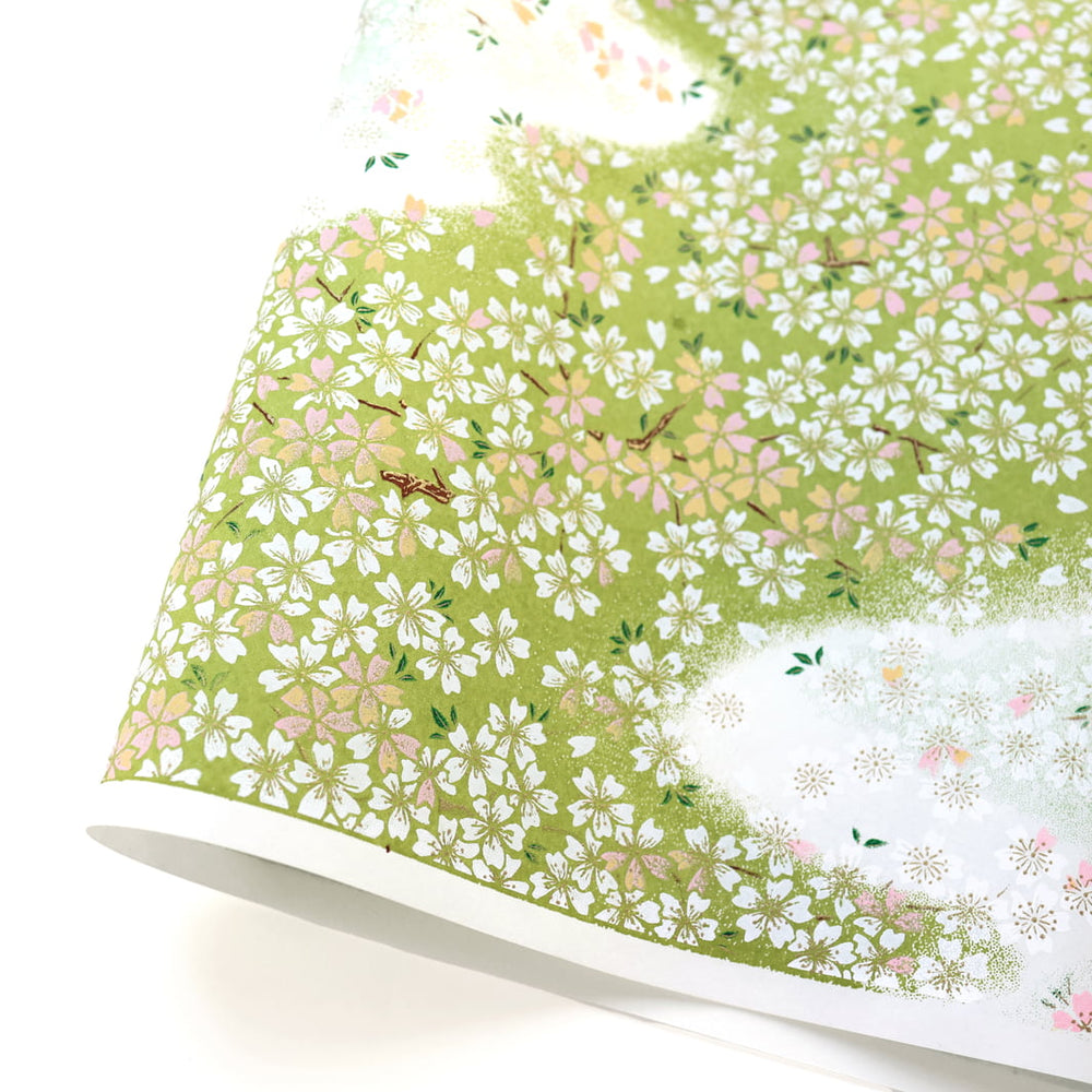 photo packshot d'une courbe de papier japonais yuzen chiyogami au motif de fleurs de cerisier dans les tons vert feuille, rose et orange pâle et blancs adeline klam (M1061)
