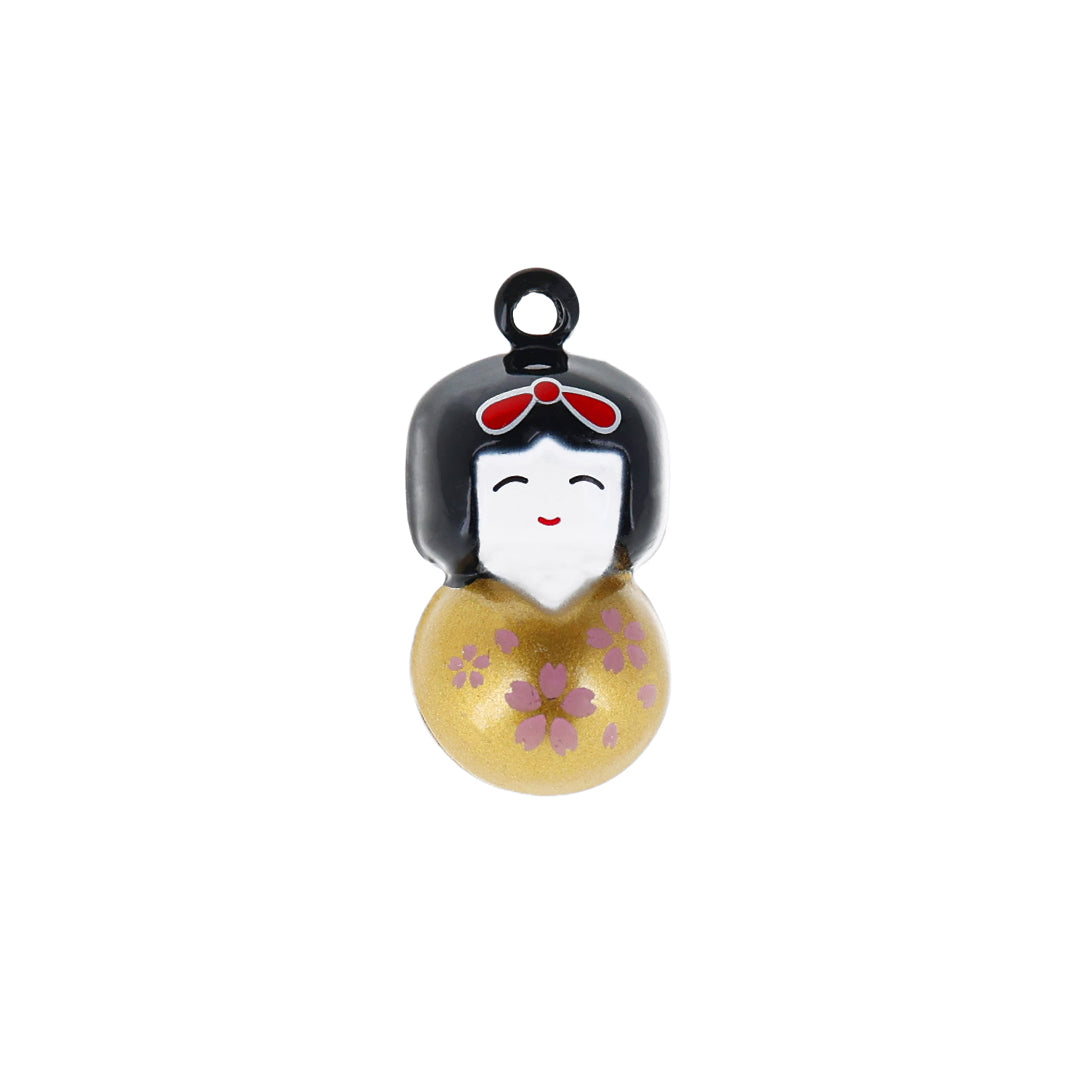 photo packshot d'un grelot en forme de kokeshi dorée