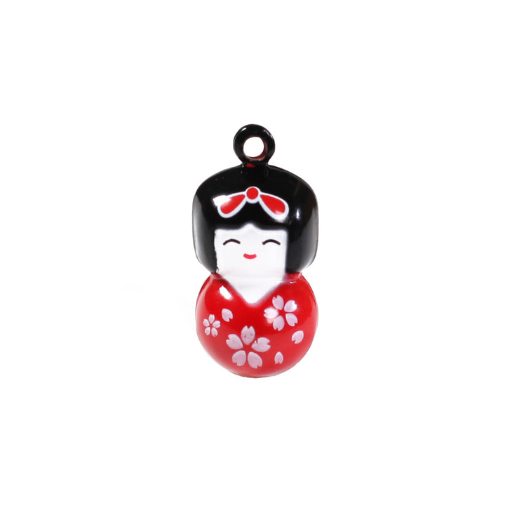 photo packshot d'un grelot en forme de kokeshi rouge
