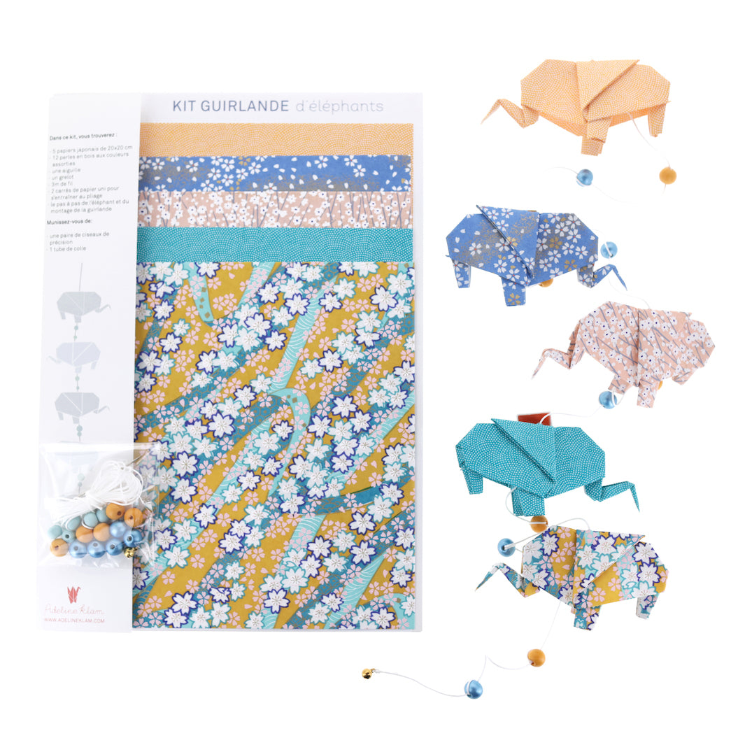 photo packshot de la guirlande montée et du matériel du kit guirlande d'éléphants en origami jaune safran, bleu pervenche, rose clair et bleu canard « bombay » adeline klam