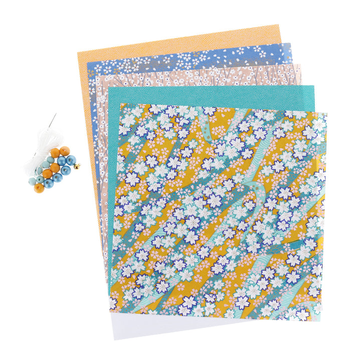 photo packshot du matériel du kit guirlande d'éléphants en origami jaune safran, bleu pervenche, rose clair et bleu canard « bombay » adeline klam