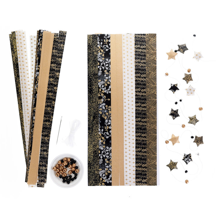 photo packshot du matériel du kit guirlande d'étoiles « gatsby » dans les tons noirs, blancs et dorés adeline klam