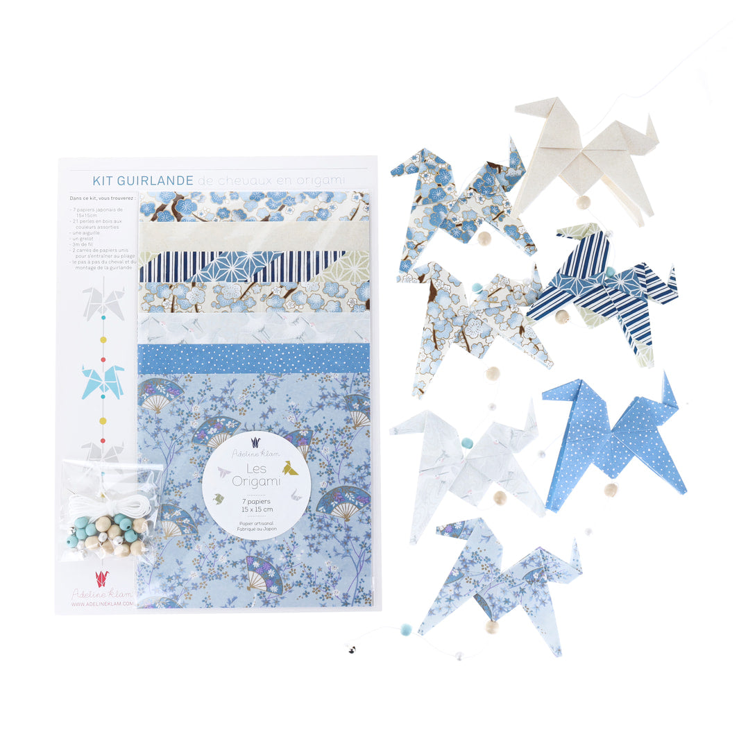 photo packshot du packaging et de la guirlande montée du kit guirlande de chevaux en origami dans les tons bleu ciel, bleu gris, blanc crème et blanc nacré « rivage » O4 adeline klam 