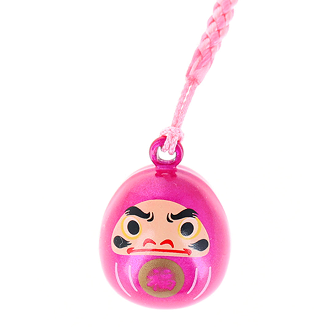 photo packshot zoomée d'un porte-clefs en forme de daruma de couleur rose fuchsia nacré