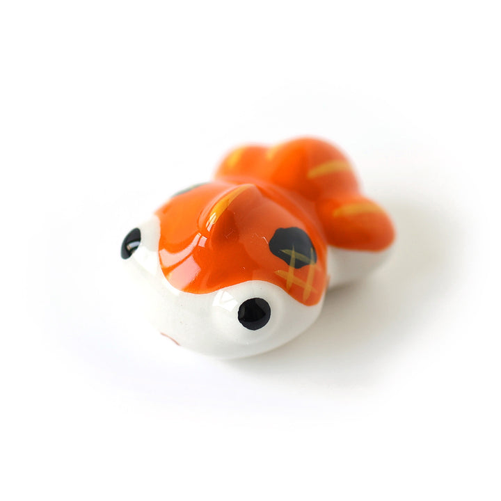 photo packshot d'un petit poisson flottant blanc et orange en céramique